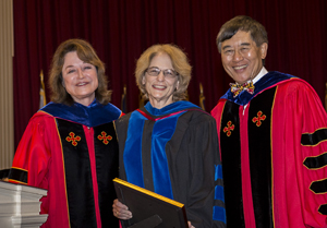 Anne Simon (center) receiving her award from UMD President Wallace D. Loh (right) and UMD Senior Vice President and Provost Mary Ann Rankin (left) at the 2018 Faculty and Staff Convocation. Photo: Stephanie S. Cordle, University of Maryland (Click image to download hi-res version.)