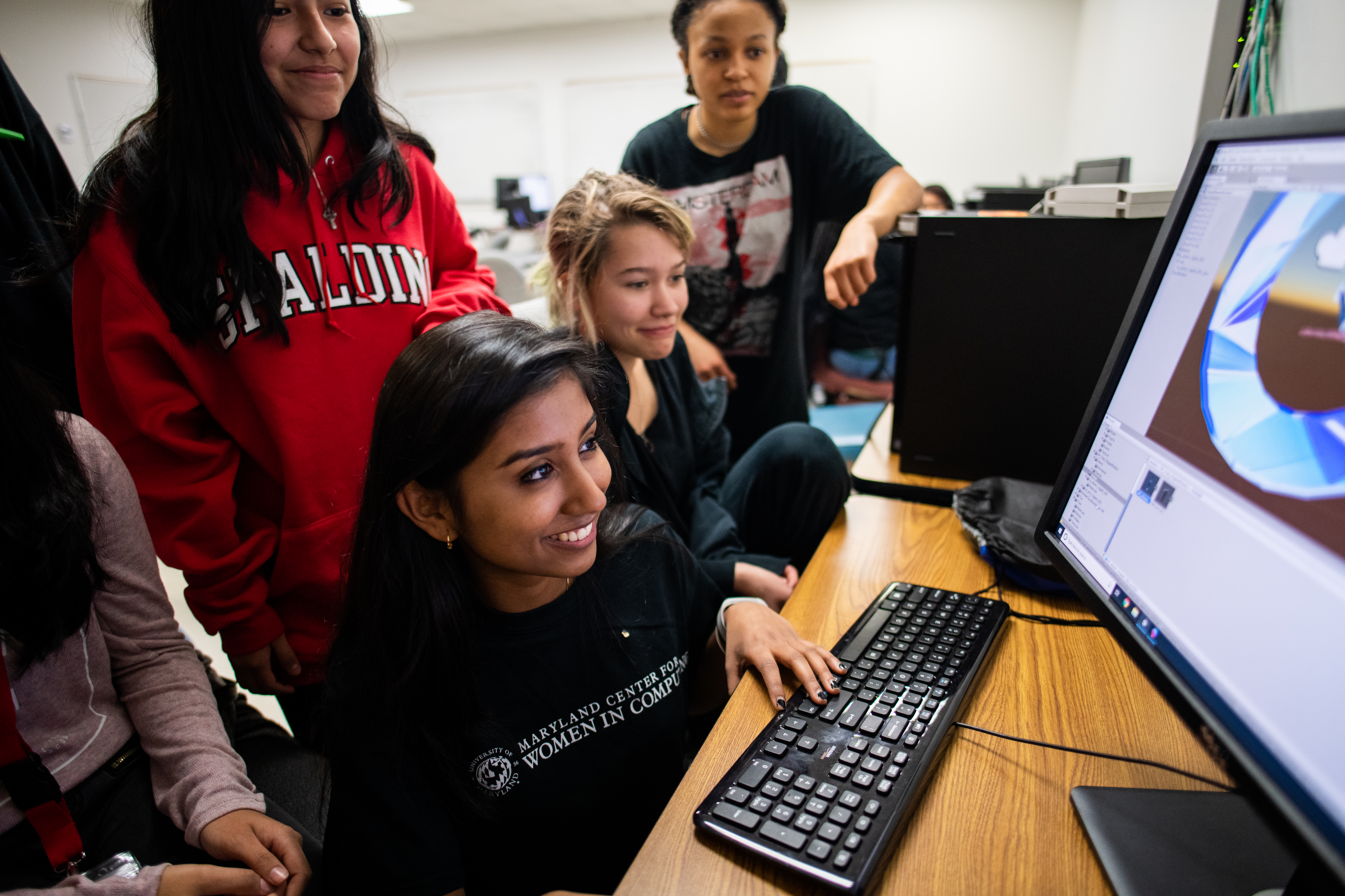 Freshman computer science major Utsa Santhosh helps participants in a weekend computing event hosted by the Maryland Center for Women in Computing. Image credit: Justin Derato (Click image to download hi-res version)