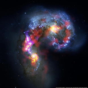 This image of the Antennae Galaxies is a composite of test observations from the Atacama Large Millimeter/submillimeter Array (ALMA) (red, pink and yellow areas) and visible light observations from the NASA/ESA Hubble Space Telescope (blue areas). The ALMA observations show the clouds of dense cold gas from which new stars form. Image by ALMA (ESO/NAOJ/NRAO); Visible light image by the NASA/ESA Hubble Space Telescope.