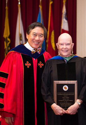 Joelle Presson (right), standing with University of Maryland President Wallace D. Loh, received her Distinguished Service Award at the 2017 Convocation. Photo: Lisa Helfert, University of Maryland (Click image to download high-res version.)