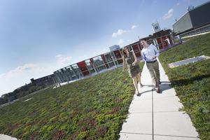 Physics graduate student Ben Reschovsky and undergraduate student Katie Hergenreder stroll on the green roof of the new Physical Sciences Complex, which earned Leadership in Energy & Environmental Design (LEED) gold certification. Photo: John Consoli (Click image to download hi-res version.)