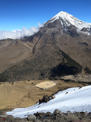 This view of the HAWC observatory was taken from the slopes of Volcán Sierra Negra. Its neighbor, Pico de Orizaba, is the highest peak in Mexico and is visible in the background. Photo: HAWC Collaboration (Click image to download hi-res version.)