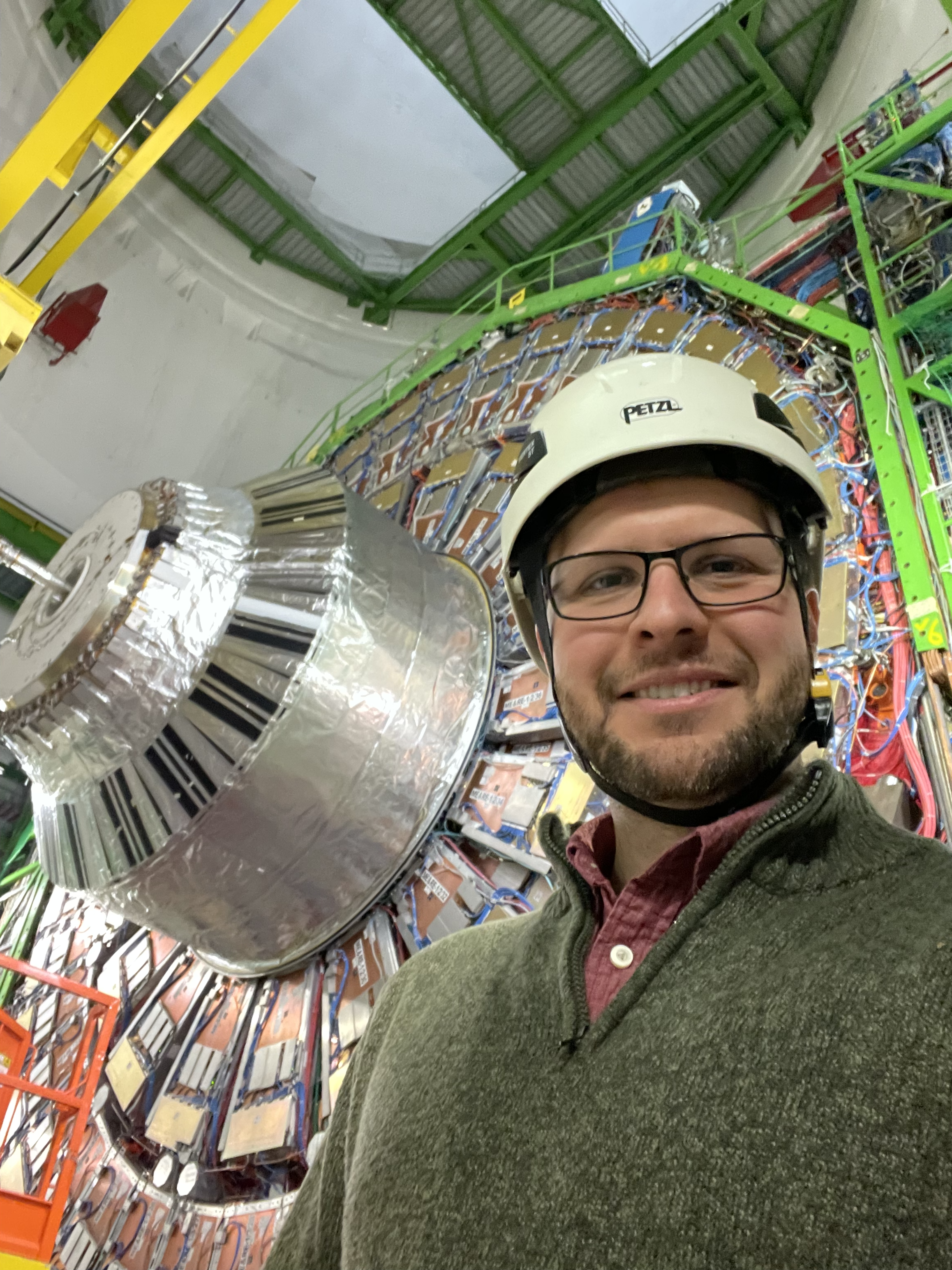 Christopher Palmer wearing a hard hat inside a lab at CERN