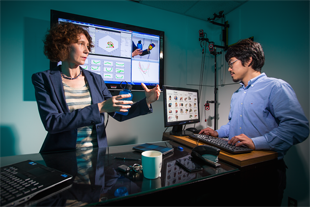 University of Maryland researcher Cornelia Ferm&uuml;ller (left) works with graduate student Yezhou Yang (right) on computer vision systems able to accurately identify and replicate intricate hand movements. Photo: John T. Consoli (Click image to download hi-res version.)
