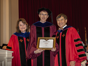 Peter Shawhan (center) receiving his award from UMD President Wallace D. Loh (right) and UMD Senior Vice President and Provost Mary Ann Rankin (left) at the 2018 Faculty and Staff Convocation. Photo: Stephanie S. Cordle, University of Maryland (Click image to download hi-res version.)