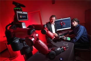 University of Maryland computer scientist Yiannis Aloimonos (center) is developing robotic systems able to visually recognize objects and generate new behavior based on those observations. Photo: John T. Consoli (Click image to download hi-res version.)