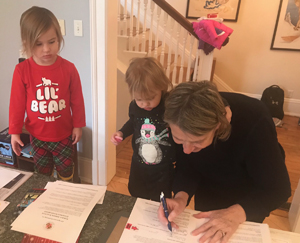 Cheryl Gibson Sullivan emphasizing the culture of philanthropy to her granddaughters as she signs her gift agreement. Photo courtesy of same. (Click image to download hi-res version.)