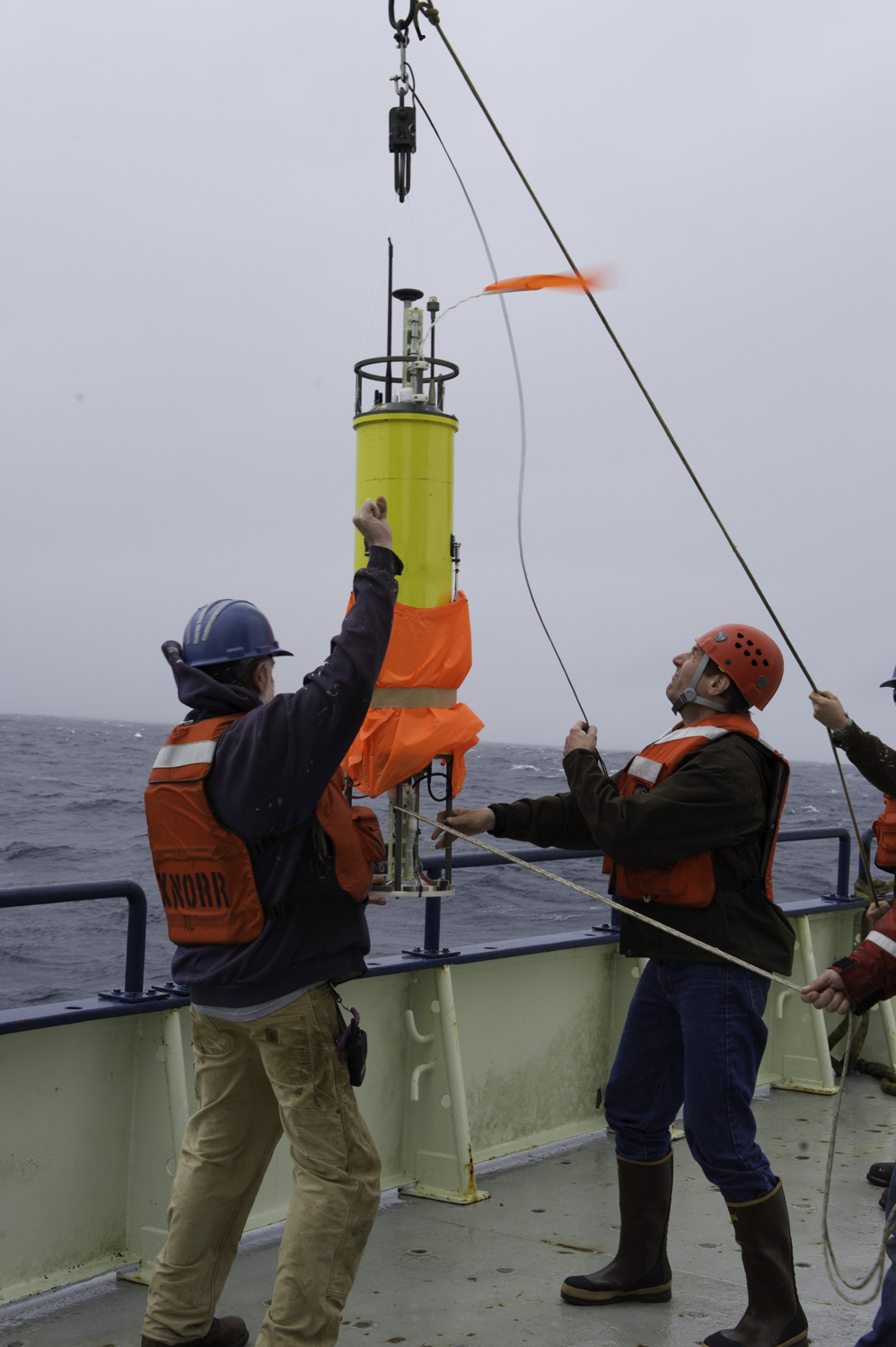 A research crew deployed a float from the R/V Knorr before releasing a fluorescent dye into the water. Scientists then tracked the drift of both dye and float through the Gulf Stream revealing significant mixing of waters across the swift current. Photo Credit: Craig M. Lee, UW APL. Click image to download hi-res version.