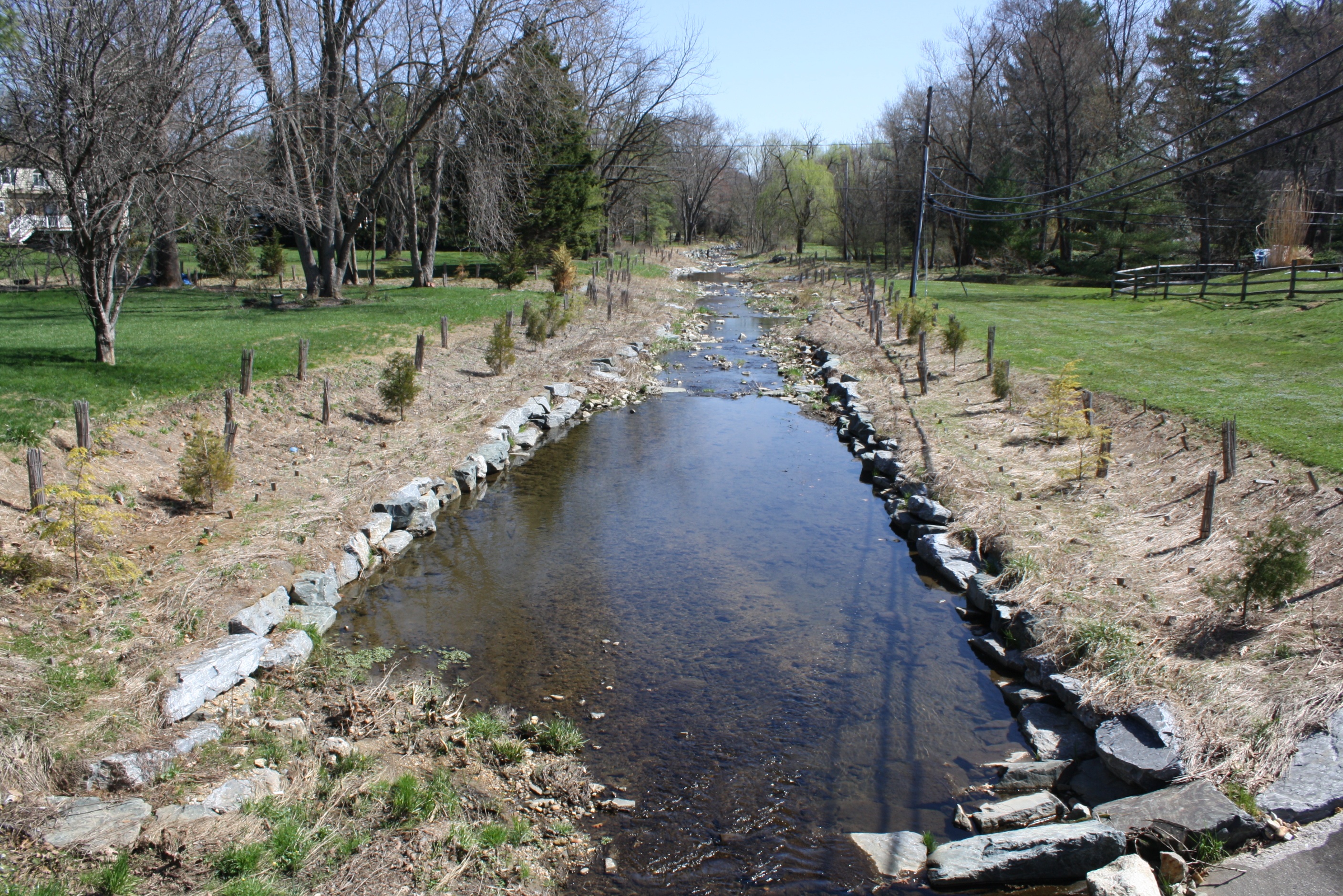This stream restoration project in Baltimore, Maryland is in an early stage of evolution towards sustainability. A concrete channel that enclosed the stream has been removed, and native tree seedlings have been planted along its banks. Credit: Tamara Newcomer Johnson, University of Maryland