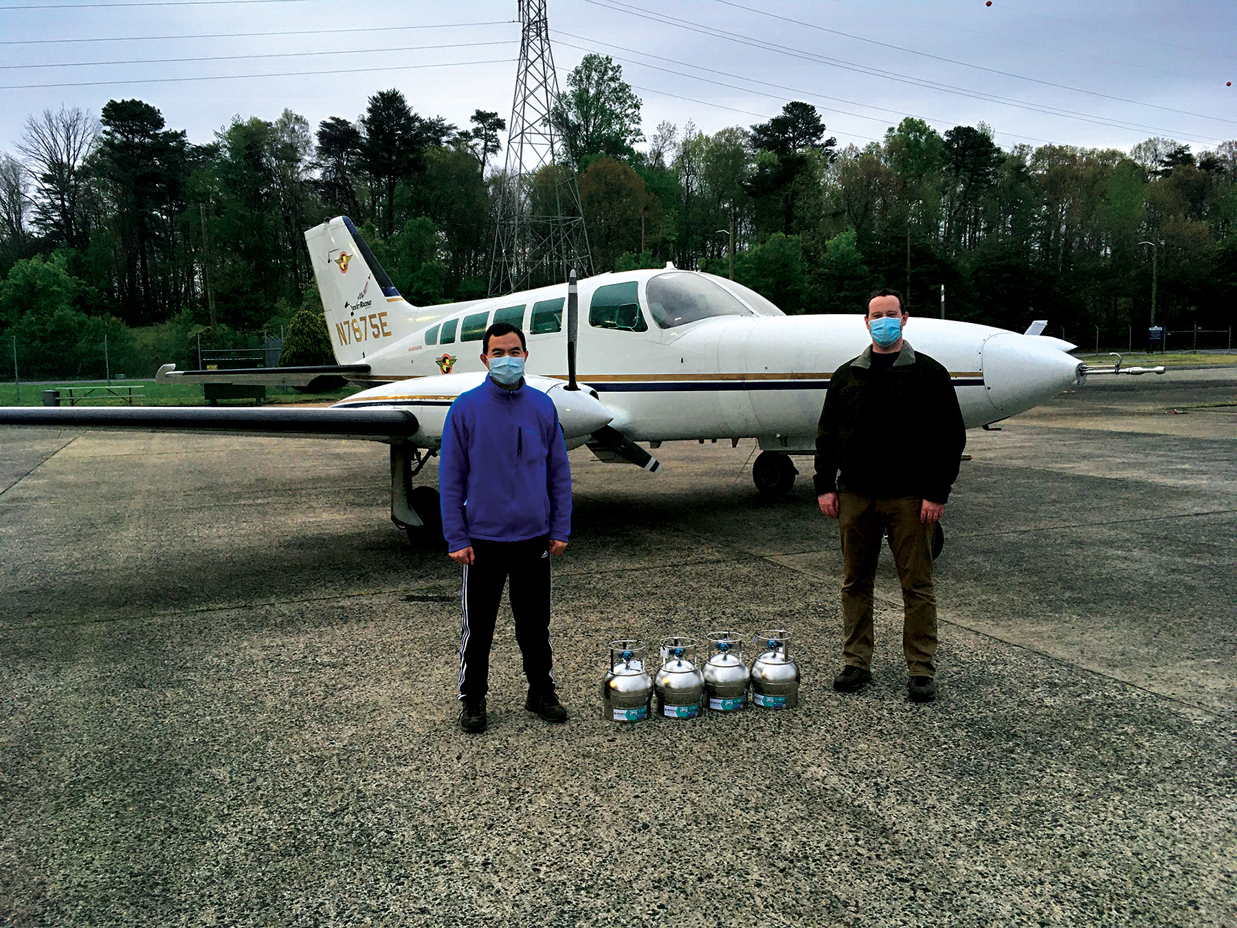 (L-R) Xinrong Ren and Phillip Stratton standing in front of a small white plane.