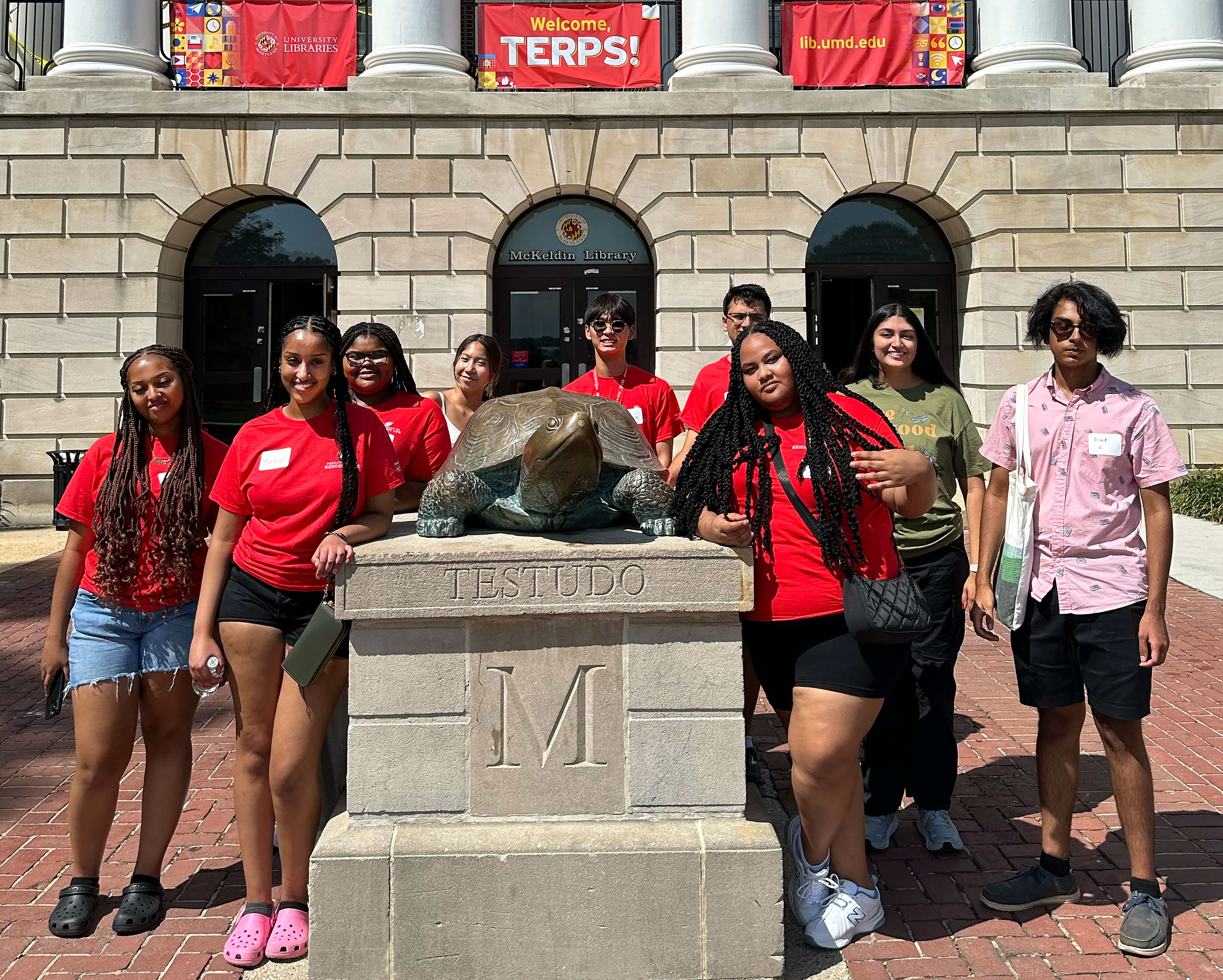 Students pose with Testudo in front of McKeldin Library