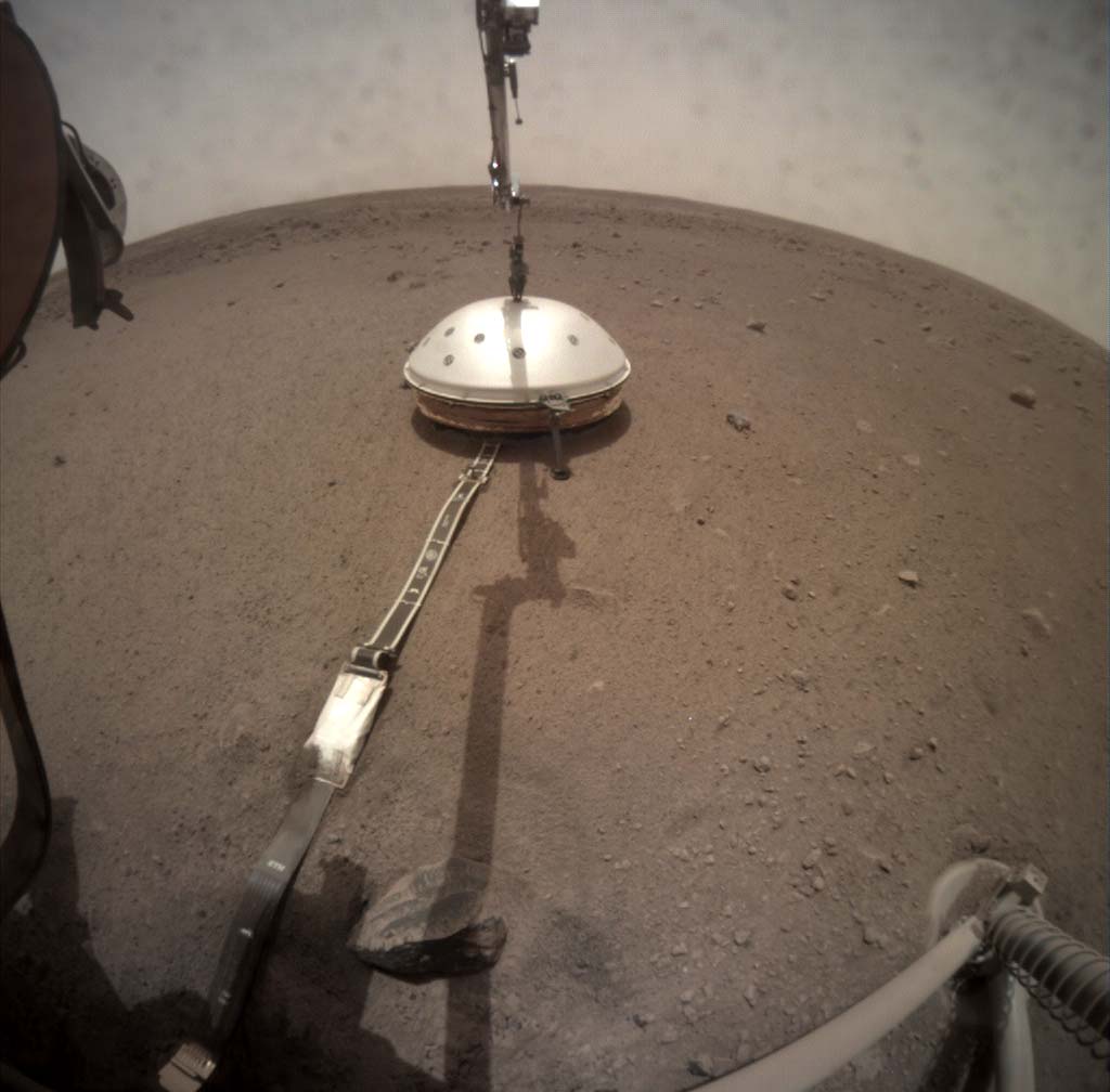 NASA's InSight lander deployed its seismometer on the Martian surface on Dec. 19, 2018. This image, captured on Feb. 2, 2019 (Martian Sol 66) by the deployment camera on the lander’s robotic arm shows the protective wind and thermal shield which covers the seismometer. Photo Credit: NASA/JPL-Caltech (Click image to download hi-res version)