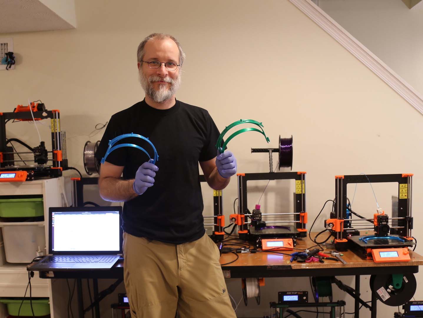 UMD associate professor of chemistry and biochemistry Paul Paukstelis in his basement with an array of 3D printers and the face shield headbands he makes and donates to keep healthcare workers safe during the COVID-19 pandemic. Click image to download hi-res version.
