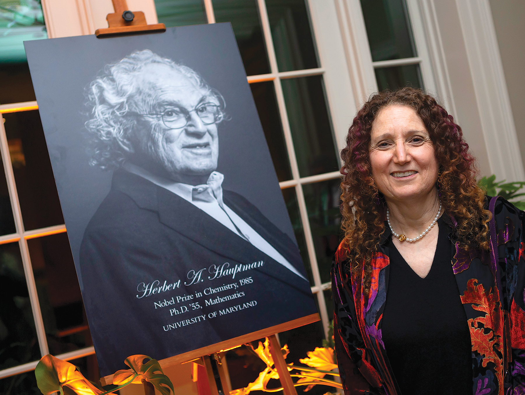 Carol Fullerton with a photo of her father, Nobel laureate Herbert Hauptman (Ph.D. ’55, mathematics). Image credit: John T. Consoli. (Click image to download hi-res version)